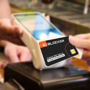ID Blocker card held over a payment terminal with a blurred background