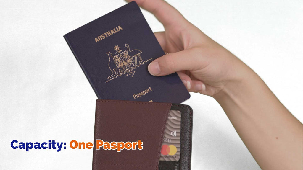 Hand placing an Australian passport into a brown Skimguard cyber passport sleeve, showing single-passport capacity and embedded card protection.
