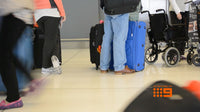 People with luggage in an airport setting